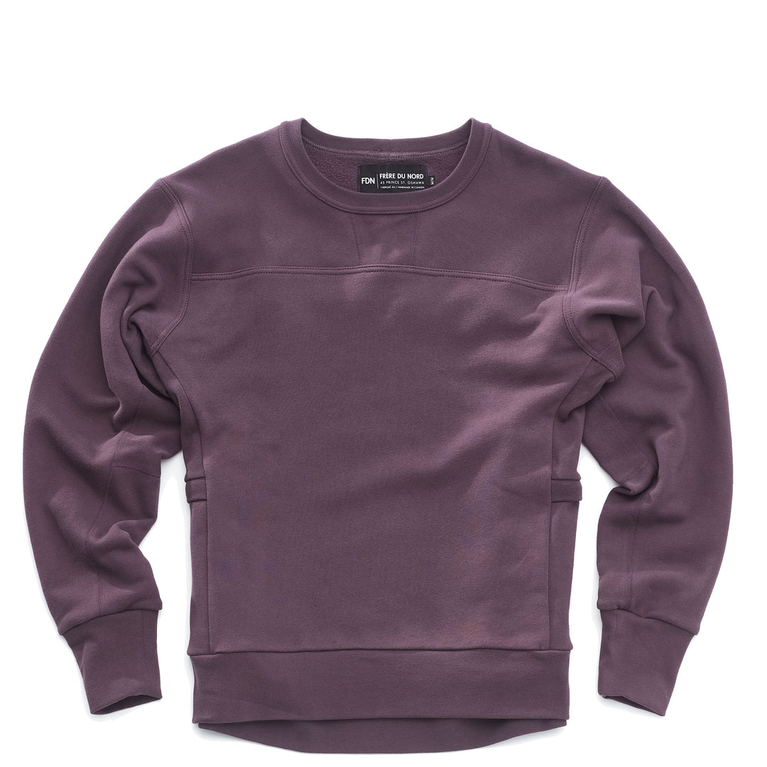 A purple crewneck sweatshirt with long sleeves, featuring a crew neck design, side panel pockets and made of a solid color fabric.