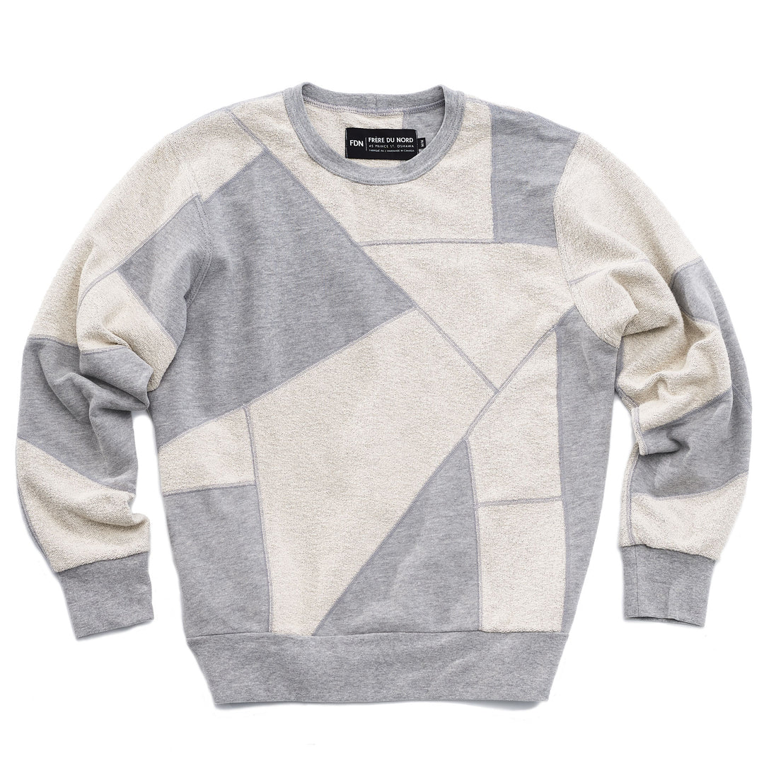 An upcycled crewneck sweater with heather grey and white pieces combined to make a unique geometric pattern.