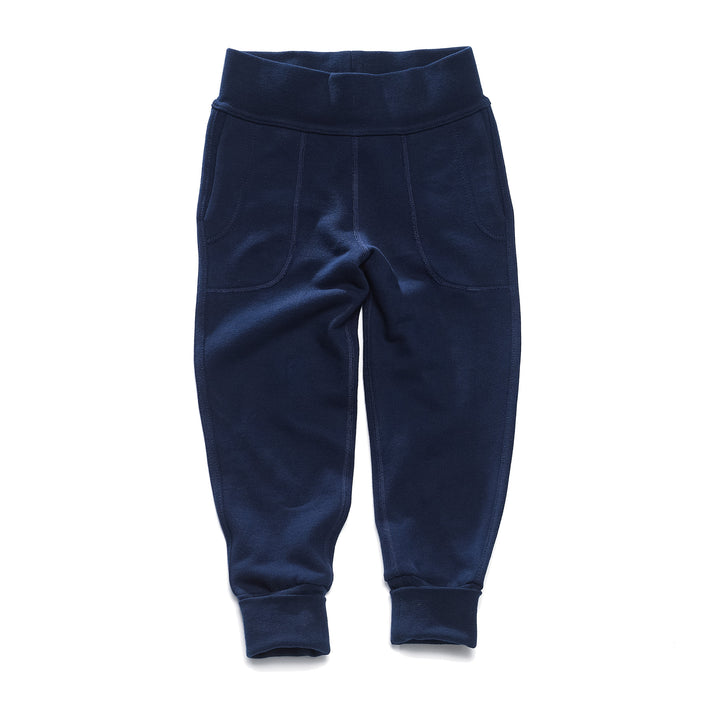 A pair of navy children's pants with flatlocked seams, top stitched waistband, and  grow with me cuffs rolled up slightly.