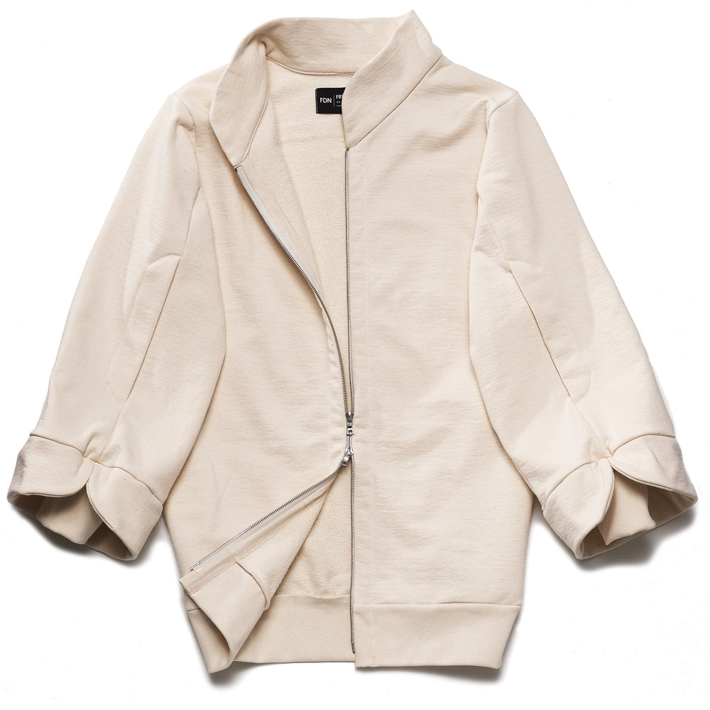 A beige, oversized tulip-shaped sleeve coat with a rib cuff and a matching petal collar, featuring a 2-way riri metal zipper and side pockets.