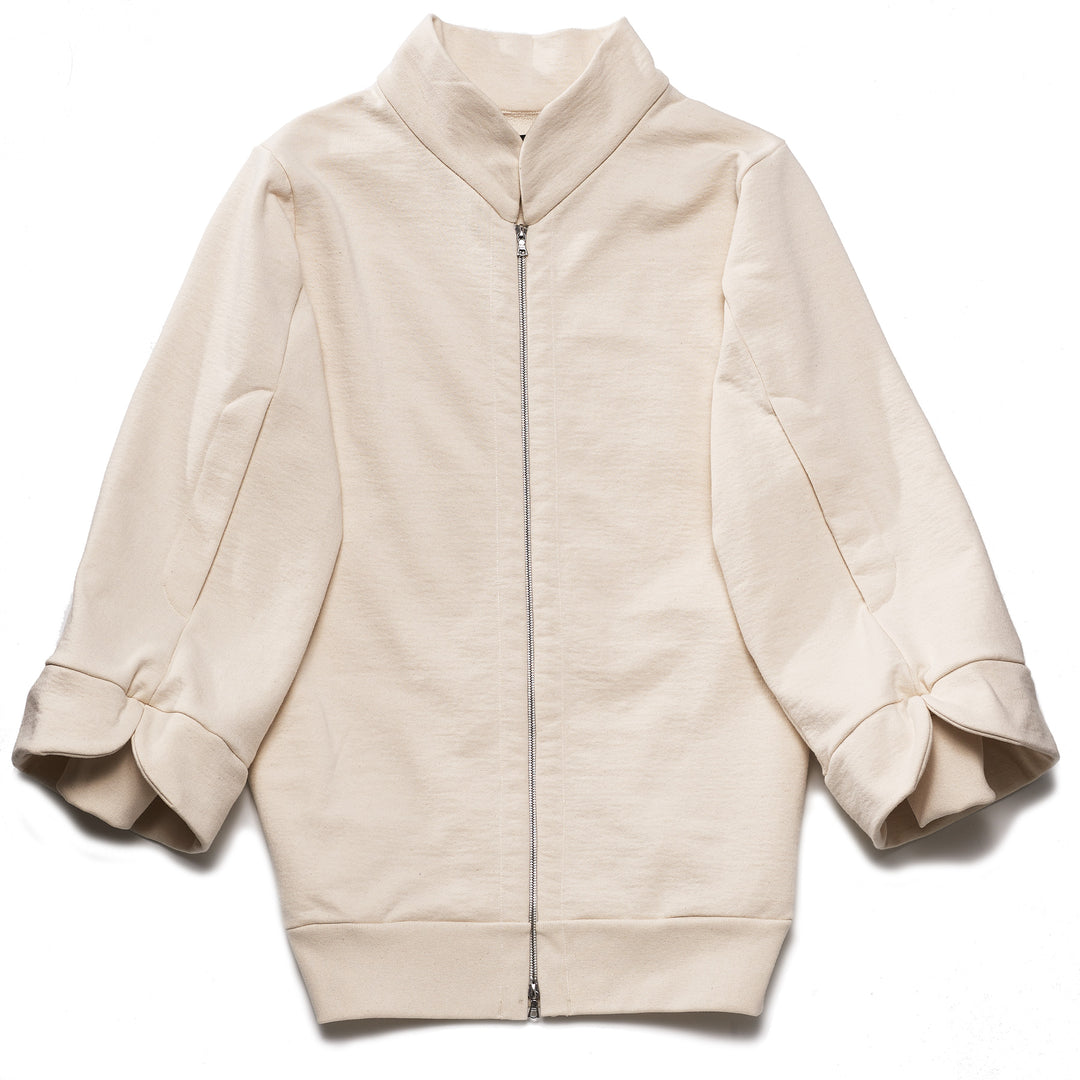 A beige, oversized tulip-shaped sleeve coat with a rib cuff and a matching petal collar, featuring a 2-way riri metal zipper and side pockets.