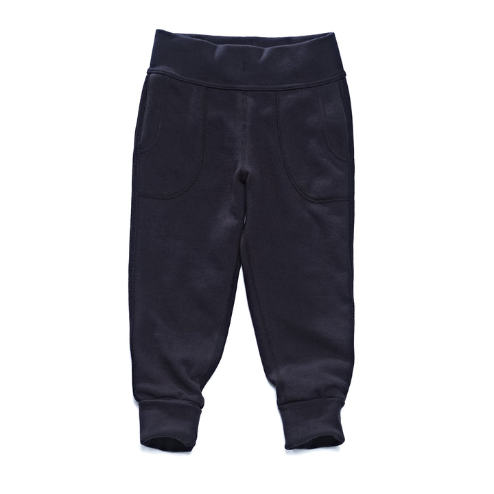 A pair of black children's pants with flatlocked seams, top stitched waistband, and  grow with me cuffs rolled up slightly.