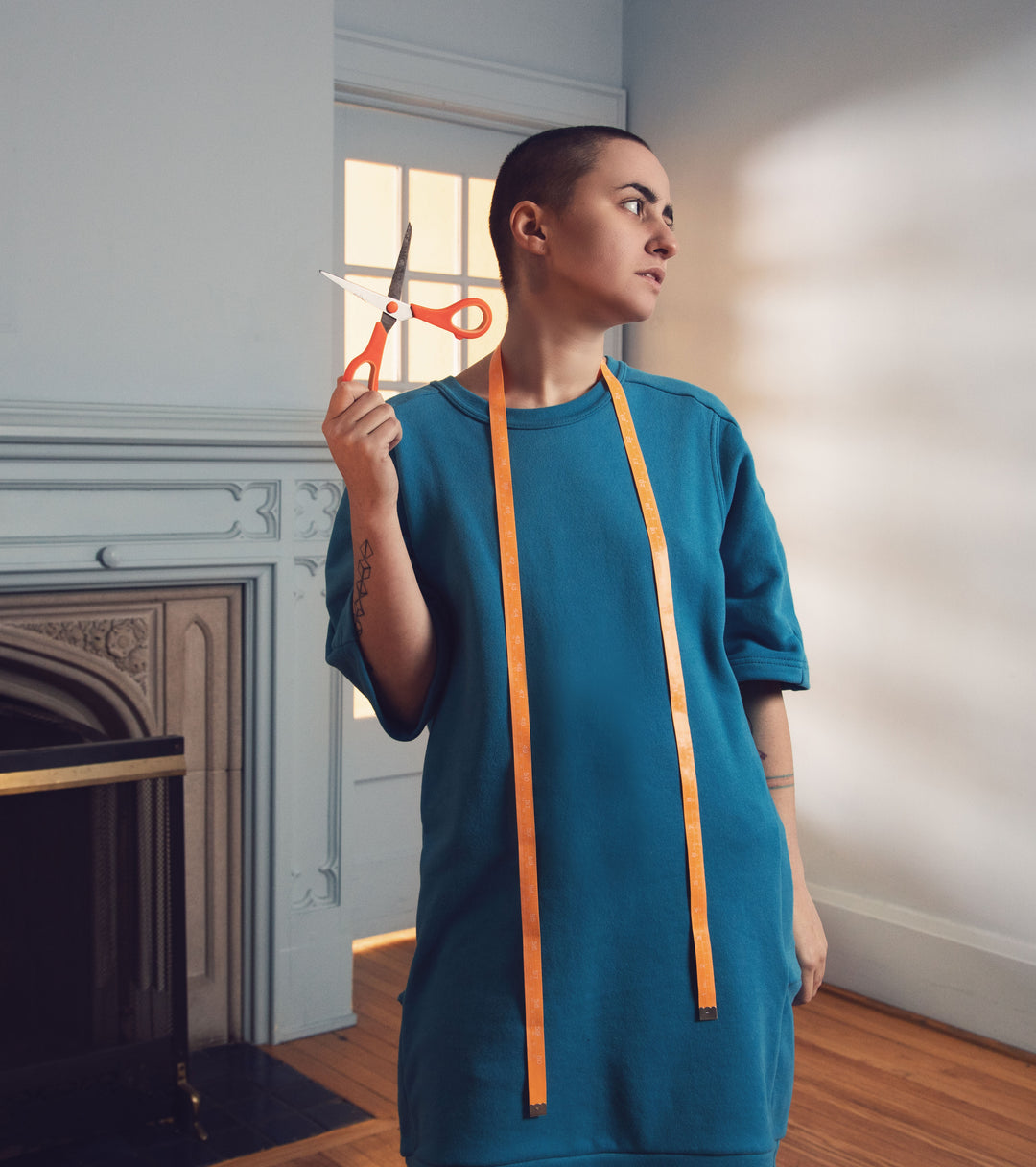 Model in Vintage Blue Tunic with scissors and measuring tape - made in Canada custom clothing