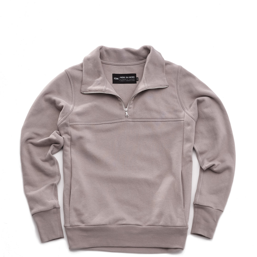Grey pullover sweater with a quarter zip silver zipper on a white background