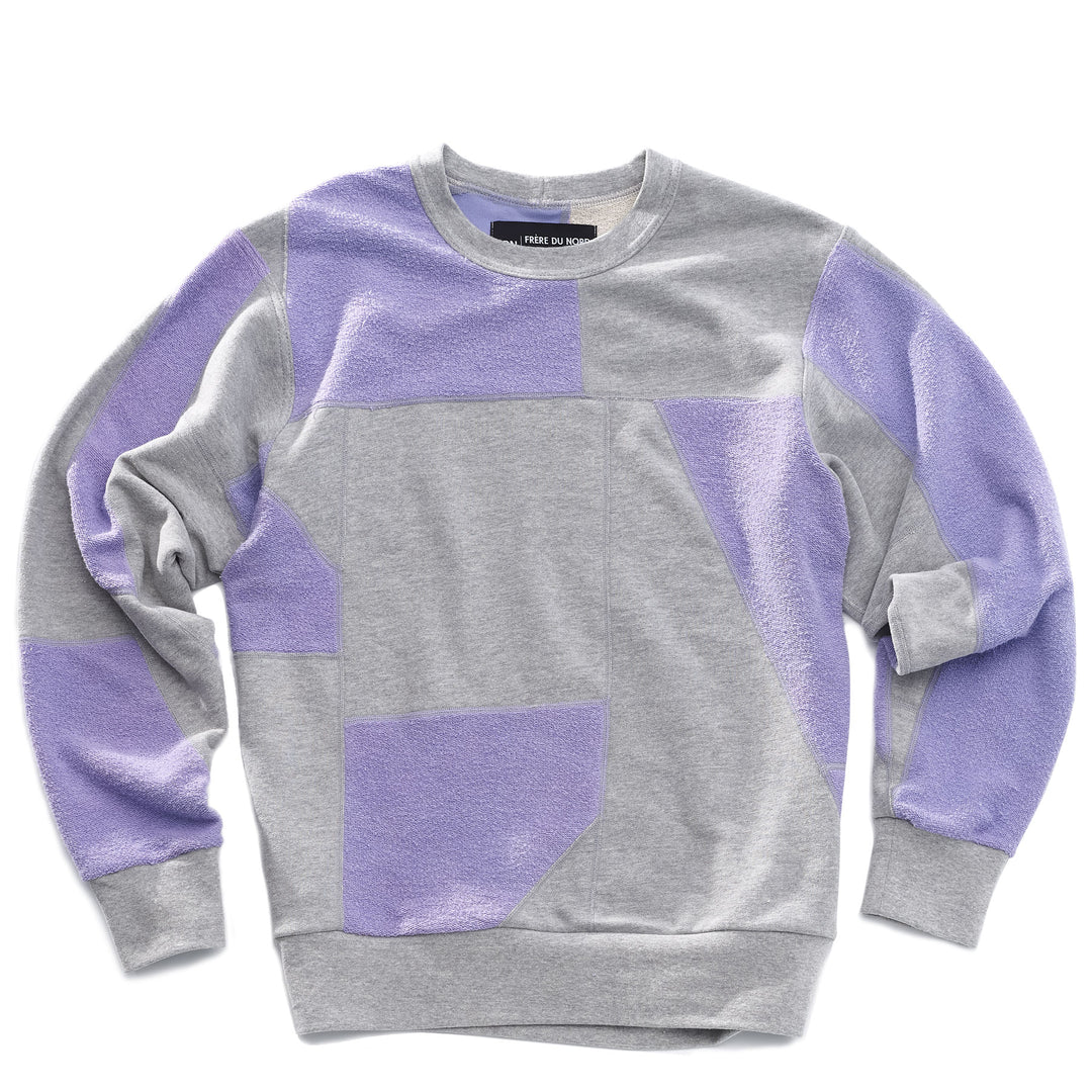 An upcycled crewneck sweater with heather grey and lavender pieces combined to make a unique geometric pattern.
