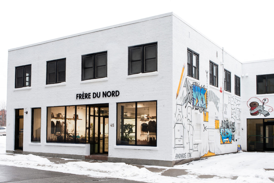 frere du nord building downtown oshawa sewing factory. white brick modern building with graffiti mural.