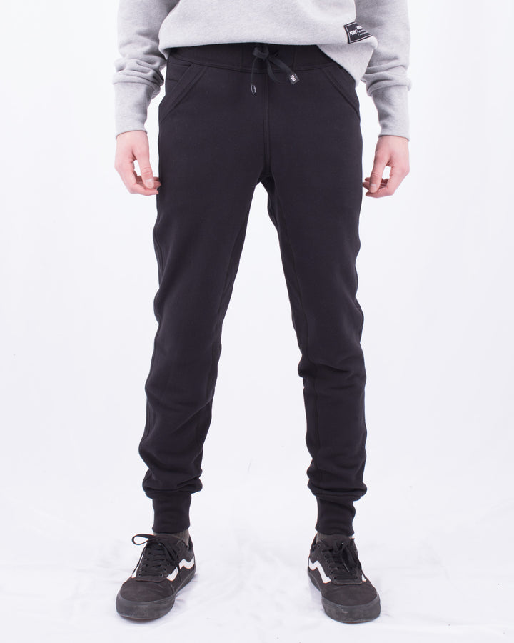 Sustainable Mens Womens Warm loungewear Sweat Pants Comfortable Luxury Black Noir Sueded Napped Soft French Felted Cotton Terry Fabriqué au Canada. High Waisted with slim tailoring in the leg. Angled front pockets with interior cellphone pockets and inner leg rib gusset. Cotton Drawcord FDN clothing made in canada