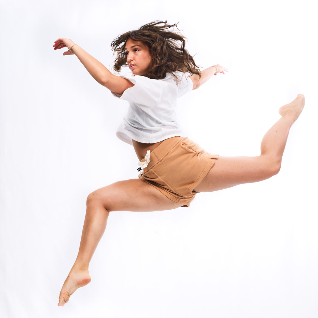 Lara Renaud wearing Short Sweat Shorts in jump pose